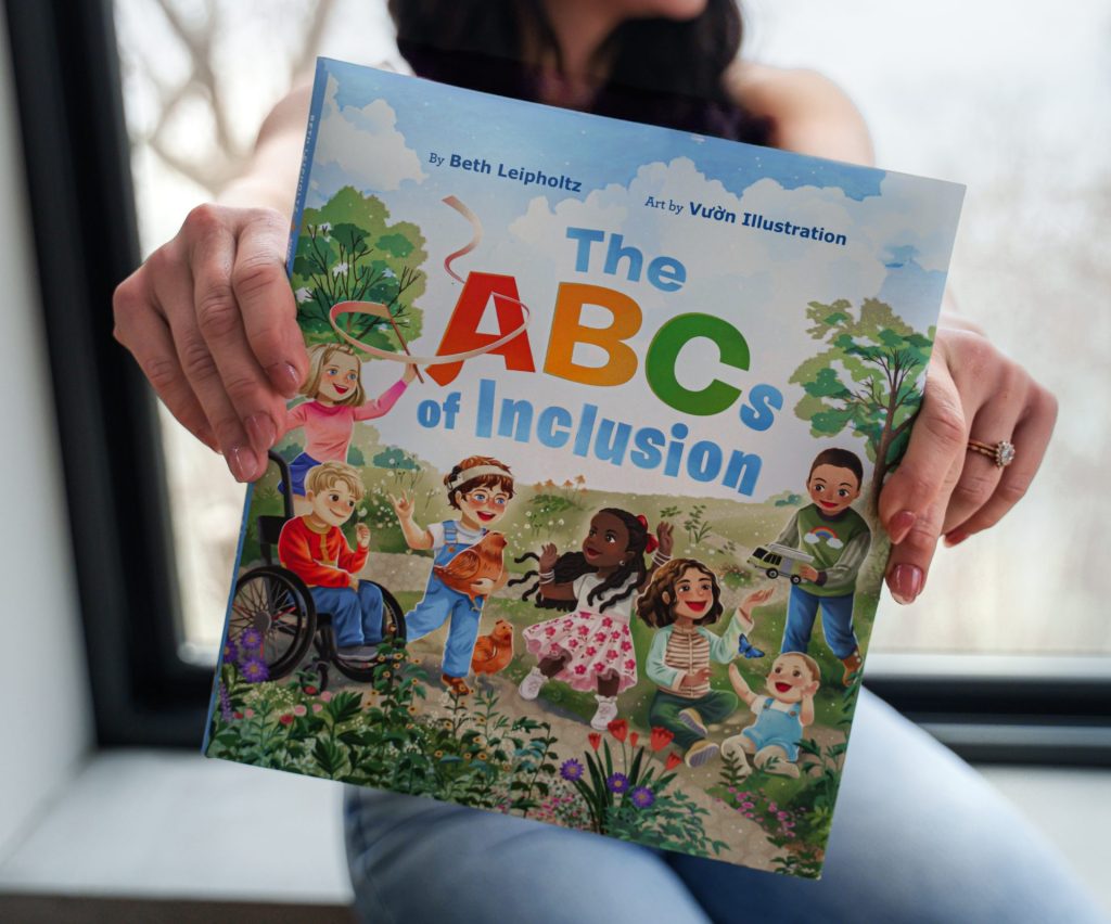 A person holds up the book 