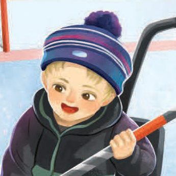 A smiling child wearing a striped winter hat and dark jacket holds a hockey stick while standing on an ice rink.